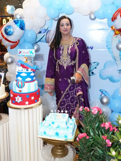 The birthday setup with the stunning tiered cake. Our balloon decoration served as the perfect backdrop for the cake cutting ceremony.