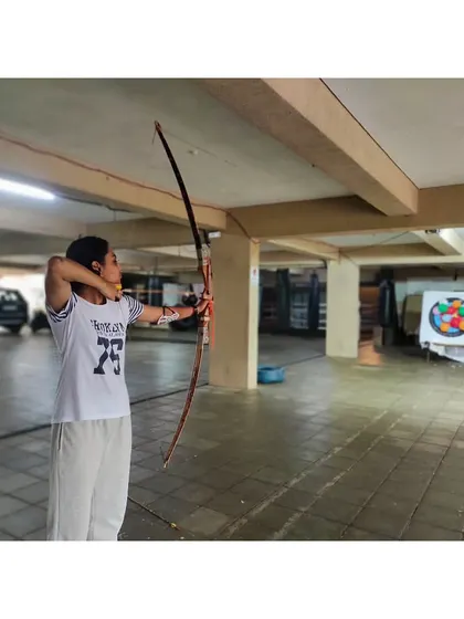 A student at full draw, demonstrating the strength and control developed during our training drills.