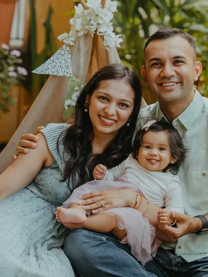 A happy family portrait during their daughter's six-month milestone shoot. Celebrating these smaller milestones together creates lasting memories.
