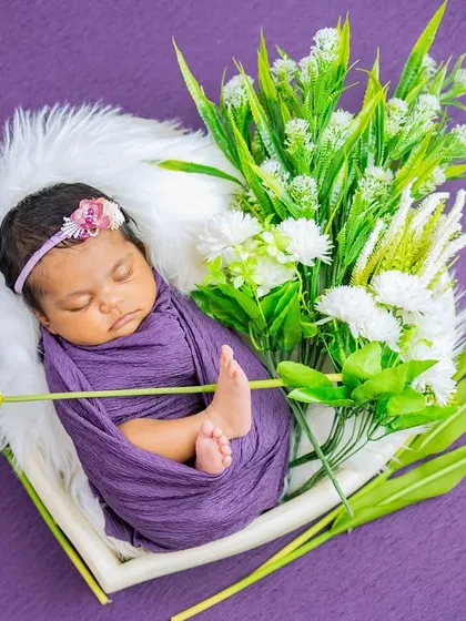 Another variation of the purple theme, this time with elegant white tulips creating a beautiful frame around the sleeping baby.