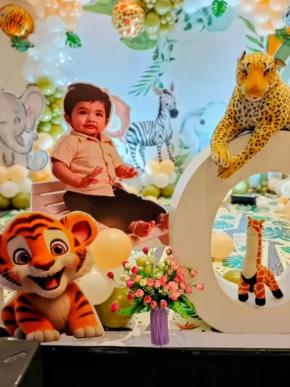 We can even include a personalized life-size cutout of the birthday child in the decor. Here, the cutout is placed next to tiger and elephant prop's, making it a memorable part of the jungle theme.