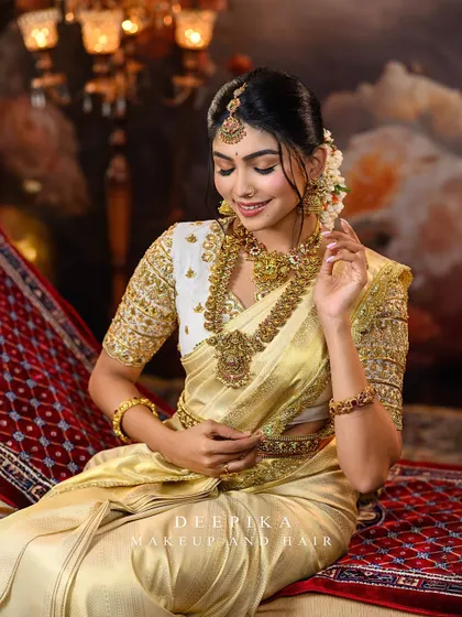 The model in a candid pose, looking down with a gentle smile, highlighting the beauty of the complete traditional look.