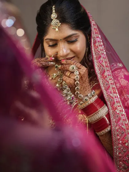Adjusting her beautiful necklace. I help with all the final details, including setting the jewelry, so my brides don't have to worry about a thing.