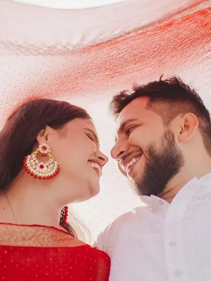 A close-up shot from the same series, focusing on the couple's joyful expressions as they look at each other. This intimate framing captures the genuine connection and happiness shared between them.