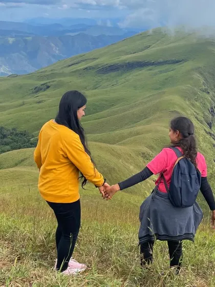 Two friends walking hand in hand on the trail, a testament to the bonds formed on these trips.