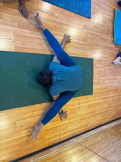 A practitioner explores a deep twist, working on flexibility and detoxification.