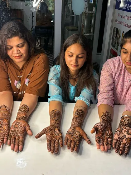 Three students proudly displaying their work after a class session. It's great to see their progress and the different styles they are developing.