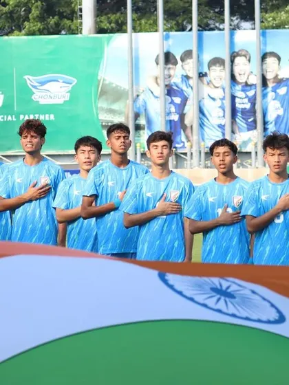 The Indian U17 team stands proudly with the national flag before their final showdown of the season. This is a powerful image of national pride and readiness for competition.