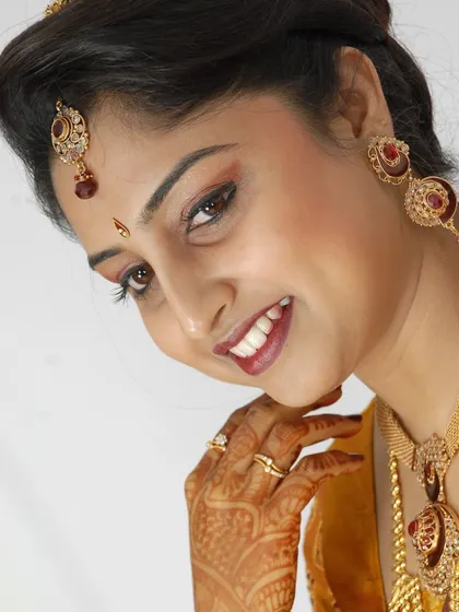 A sweet and simple bridal portrait with a clean white background, focusing on her smile.
