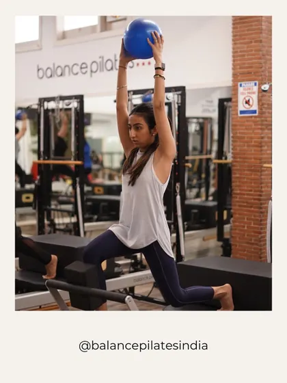 A reformer lunge with a stability ball. This move challenges balance, leg strength, and shoulder stability all at once.