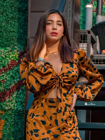 A stylish shot from an outdoor cafe, perfect for an influencer's lookbook. The composition uses the stairs to create a dynamic angle.