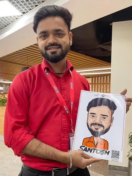 A client proudly holding his finished digital caricature at a corporate event. These portraits are printed instantly, making them a great interactive giveaway.