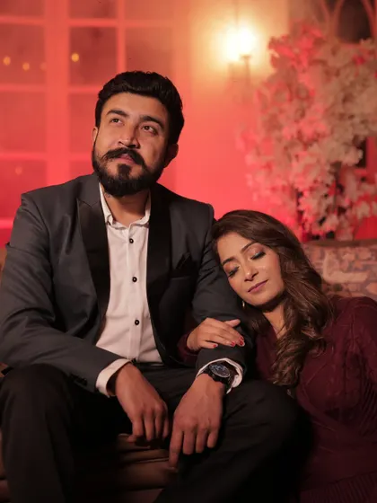 A dramatic and romantic shot from a pre-wedding session. The makeup features a slightly bolder eye to stand out in the warm, low-light setting.