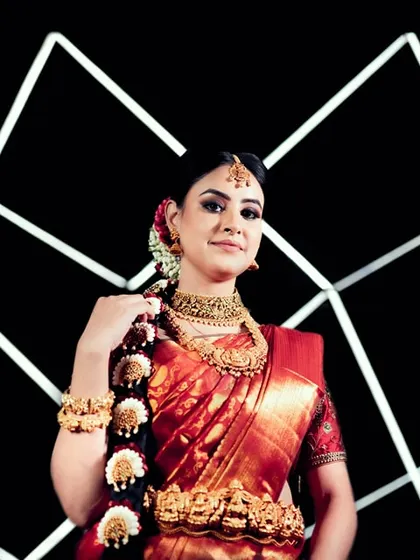 A bold and graphic bridal portrait. The bride is posed against a black background with geometric white lines of light, creating a futuristic and high-fashion look.