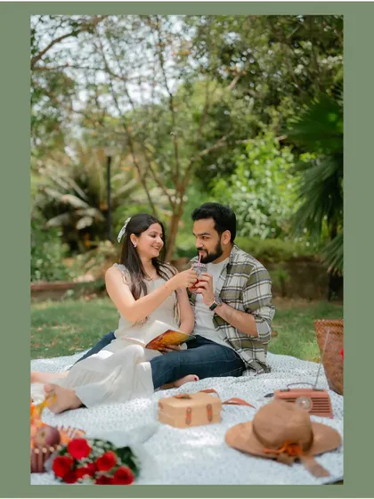 A sweet moment of the couple sharing a drink during their romantic picnic, highlighting the small, intimate gestures.