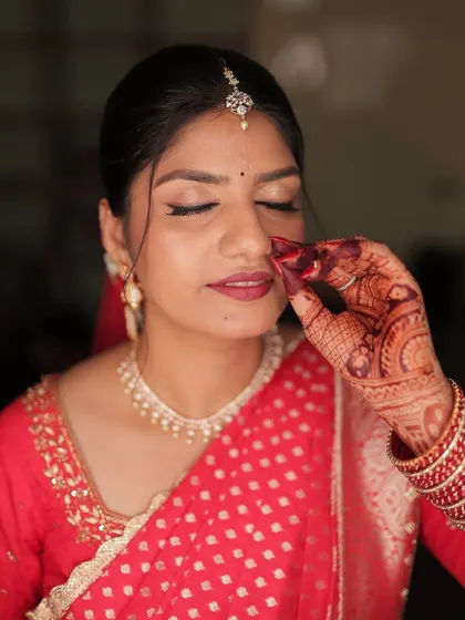 Her henna stain tells stories of love. A close-up of the bride's hand, showcasing the rich color and intricate design.