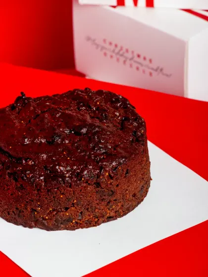 A single Christmas Fruit Cake, ready to be boxed up.