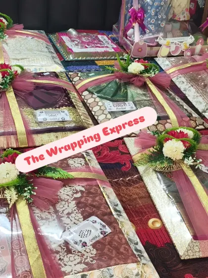 A closer look at the individually packed and decorated trays of clothes for a baby girl's trousseau.