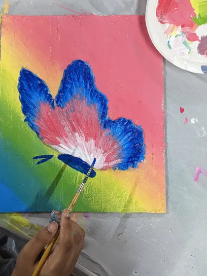 A close-up of a butterfly texture painting in progress. The combing technique used for the wings creates a delicate, feathery effect.