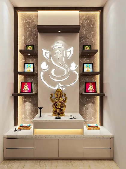 This pooja unit features a large, backlit Ganesha silhouette on a textured wall. The marble platform and beige cabinets create a soft and elegant base.