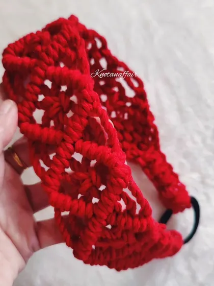 This intricately hand-knotted macrame hairband in red is a real statement piece. It comes with an adjustable band and is perfect for long wear.
