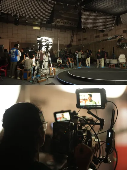 A wide shot of the studio during the CRED shoot, showing the large overhead softboxes and lighting grid used to control the environment.