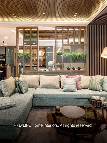 A close-up of the stylish living room with a mix of textures, including a chevron wall, wood ceiling, and a combination of leather and fabric seating.