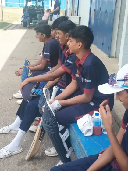 Players waiting for their turn to bat during the Trinidad tour. These experiences teach patience, focus, and adaptability.
