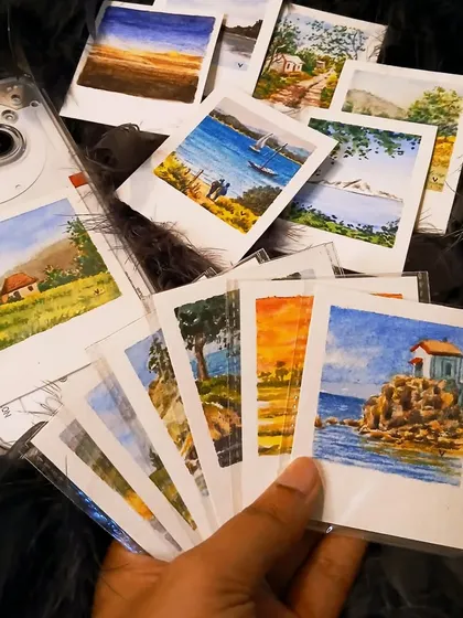 Here’s a look at how you can style my mini watercolor Polaroids. This image shows a collection of different landscapes ready to be used, with one already personalizing a clear phone case.