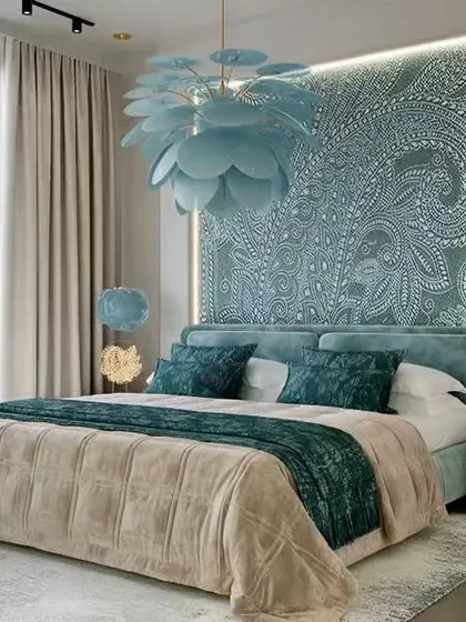 A stunning master bedroom with a large, backlit paisley-patterned headboard and a beautiful floral chandelier.