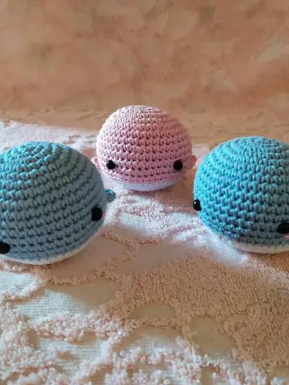 A trio of my crochet whales in different shades of blue and pink. They are small enough to fit in your palm and make adorable decorative pieces.