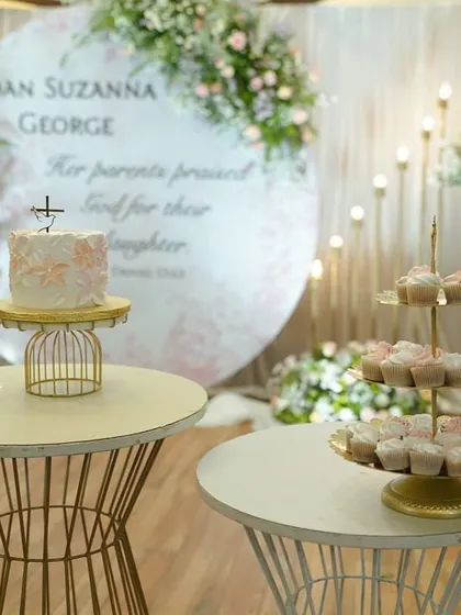 Here’s a full dessert table I created for a baby girl's baptism. It features a delicate floral painted cake and dozens of matching peach and white cupcakes on a tiered stand. I can help you create a beautiful and delicious focal point for your event.