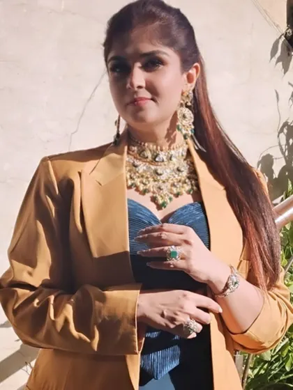 A full view of the festive jewelry look, demonstrating how to layer bold pieces for a majestic touch.