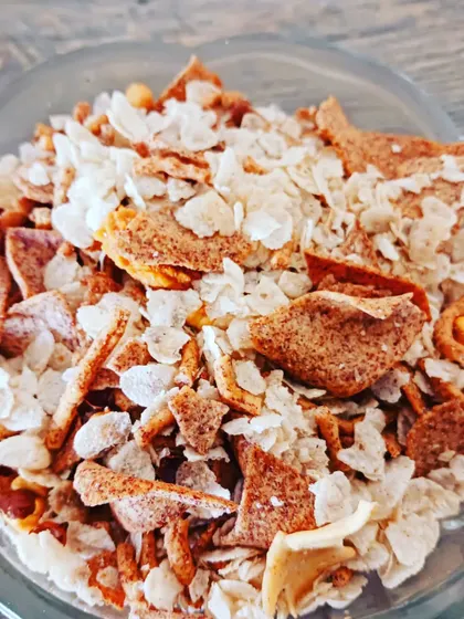 A delightful roasted poha (rice flake) chivda, mixed with nuts and spices for a light and flavorful snack.