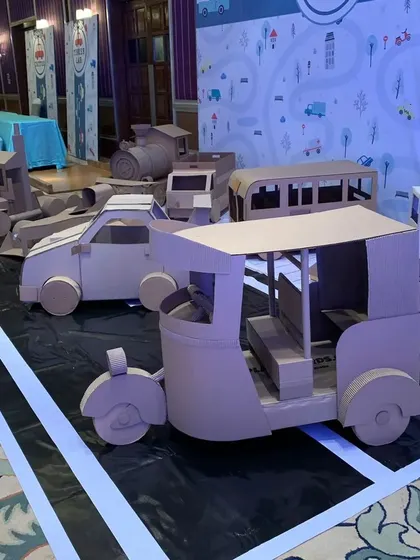 To add some local flavor to the 'Paint Shop' theme, I built this cardboard auto-rickshaw. It's a fun, recognizable vehicle that kids loved climbing into and pretending to drive.