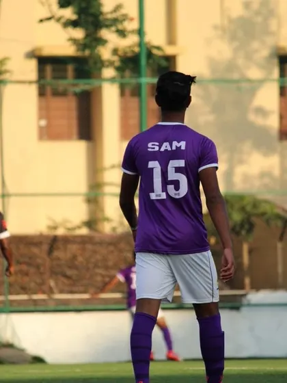 The number 15, Samanyu Nag, seen from behind. He is a player who leads by example on the pitch.