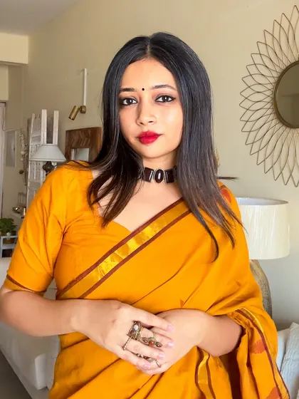 A portrait focusing on the stone choker and the simple bindi, completing the traditional look for Durga Puja.