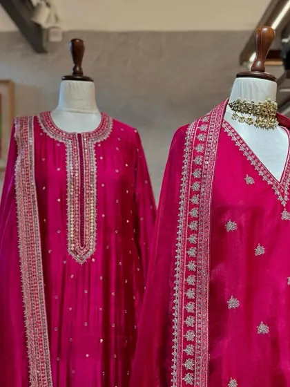 A detailed shot of the silver embroidery on a fuchsia silk suit. This is the kind of craftsmanship that elevates an outfit from beautiful to breathtaking.