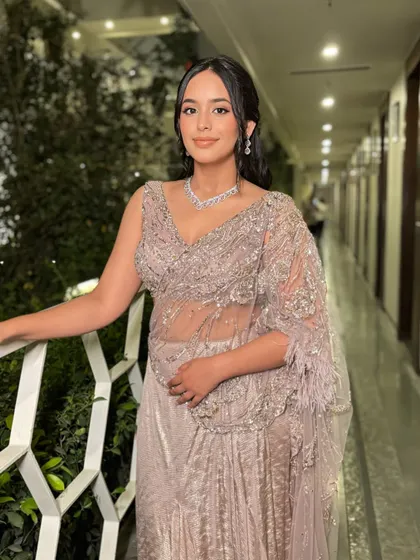 An elegant evening look. The soft makeup and beautiful side-swept hair create a romantic and sophisticated vibe, perfect for a cocktail or reception.