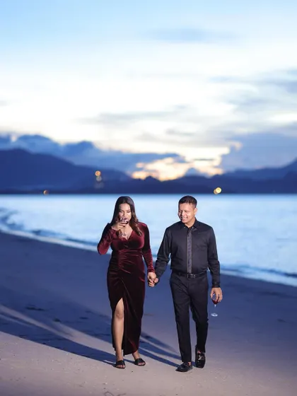 A romantic walk on the beach at sunset. The makeup is soft and glowing, catching the beautiful twilight.