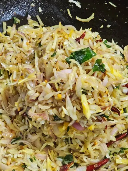 A preparation of shredded cabbage stir-fried with onions and spices.