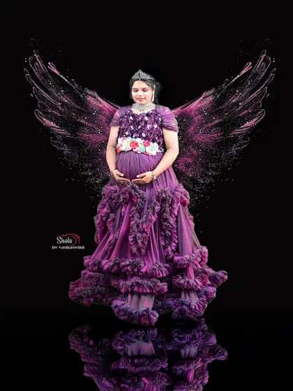 A creatively edited maternity photo featuring our purple ruffle gown with added angel wings. I love working with clients to create these unique, magical portraits.