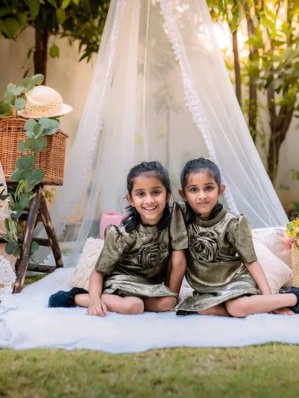 A lovely picnic setup for twin sisters celebrating their fifth birthday. This wide shot shows the full, charming setup we created for their special outdoor milestone session.