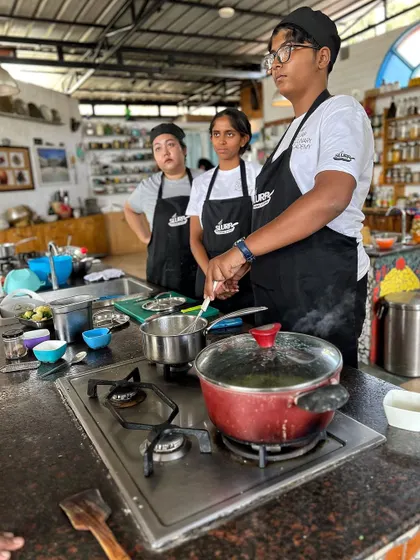 Students in our academy kitchen, listening intently during a lesson on stocks and sauces.