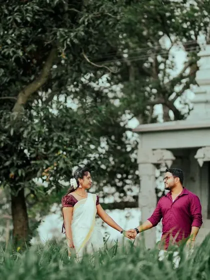 A duplicate of ID 47, where a couple holds hands and walks through a field, with a small temple adding a touch of tradition to the natural landscape.