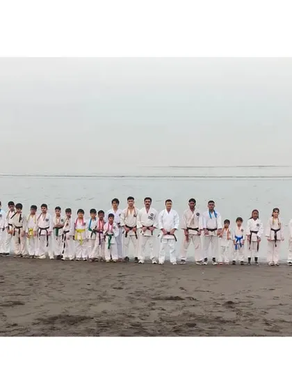 A panoramic group photo of all participants at our winter training camp, held at the beach. Training in nature builds resilience and a different kind of strength.