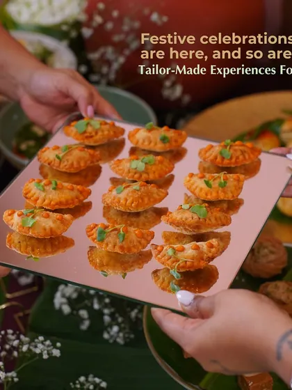 A tray of our festive Paneer Ghee Roast Gujiya being passed between guests. This image captures the spirit of sharing and celebration that defines our festive catering services.