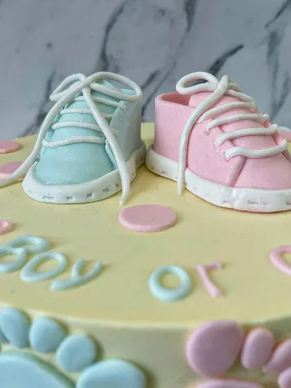 A close-up of the incredibly detailed fondant baby shoes. I love making these tiny toppers; they are the perfect keepsake from a special celebration.