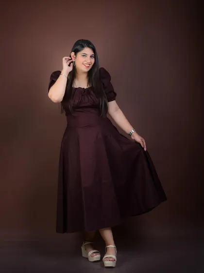 A full-length photo in a modern dress against a simple studio background. This shows versatility and a contemporary sense of style.