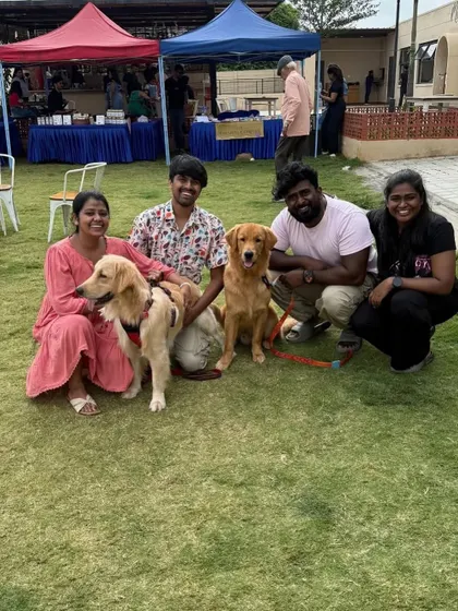 A group of friends and their two golden retrievers posing on the lawn. Our large events are a great opportunity for your dogs to socialize and make new friends.